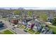 Aerial view of a neighborhood with a two-story home in the foreground with lush landscaping and front yard at 1724 Prospect St, Indianapolis, IN 46203