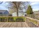 Backyard with wooden deck overlooking grass and large shade tree at 1724 Prospect St, Indianapolis, IN 46203