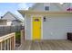 Backyard deck next to a bright yellow door provides outdoor access to the home at 1724 Prospect St, Indianapolis, IN 46203
