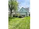 Beautiful backyard with a well-maintained lawn and charming deck, and mature trees at 1724 Prospect St, Indianapolis, IN 46203