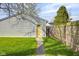 Backyard with yellow door on detached garage and green grass at 1724 Prospect St, Indianapolis, IN 46203