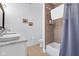 Bright bathroom features dual sinks, a shower with tile surround, and modern fixtures at 1724 Prospect St, Indianapolis, IN 46203