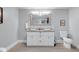 A bright bathroom features a double vanity with white cabinets, granite countertops, and a toilet at 1724 Prospect St, Indianapolis, IN 46203