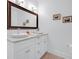 Bright bathroom featuring dual sinks, a granite countertop, and framed art at 1724 Prospect St, Indianapolis, IN 46203