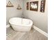 Relaxing bathroom showcasing a standalone soaking tub and decorative wall art at 1724 Prospect St, Indianapolis, IN 46203