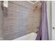 Modern bathroom with tiled walls, shower head, and purple shower curtain at 1724 Prospect St, Indianapolis, IN 46203