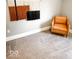 Neutral toned corner bedroom with a comfortable tan chair and decorative wall hanging at 1724 Prospect St, Indianapolis, IN 46203