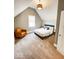 Cozy bedroom with sloped ceilings, a comfortable chair, and natural light at 1724 Prospect St, Indianapolis, IN 46203