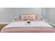 A cozy bedroom features plush, light pink bedding with an array of decorative throw pillows at 1724 Prospect St, Indianapolis, IN 46203