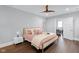 A cozy bedroom features a decorative ceiling fan and plush, light pink bedding on a gold frame bed at 1724 Prospect St, Indianapolis, IN 46203
