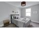 Comfortable bedroom features a stylish bed with gray bedding and matching nightstands and a window at 1724 Prospect St, Indianapolis, IN 46203
