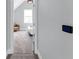 A cozy bedroom features plush carpeting and a comfortable reading nook with a leather chair at 1724 Prospect St, Indianapolis, IN 46203