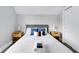 Well-lit bedroom features a large bed with blue pillows and side tables at 1724 Prospect St, Indianapolis, IN 46203