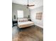 Bright bedroom with a ceiling fan, carpeted floors, and decorative wall art at 1724 Prospect St, Indianapolis, IN 46203
