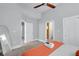 Bright and spacious bedroom featuring a modern ceiling fan and neutral tones, leading to a well-appointed bathroom at 1724 Prospect St, Indianapolis, IN 46203