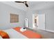 Bright bedroom with a ceiling fan and neutral tones, along with a view of the bathroom, creating a relaxing retreat at 1724 Prospect St, Indianapolis, IN 46203