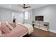 Cozy bedroom featuring light pink bedding, a television, and a modern white and gold shelving unit at 1724 Prospect St, Indianapolis, IN 46203