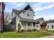 Inviting two-story house with a white-railed porch, neat landscaping, and pleasant curb appeal at 1724 Prospect St, Indianapolis, IN 46203