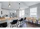 Contemporary kitchen featuring a breakfast bar with pendant lighting, stainless appliances, and bright windows at 1724 Prospect St, Indianapolis, IN 46203