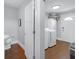 Bright laundry room with washer, dryer, cabinets, and modern door at 1724 Prospect St, Indianapolis, IN 46203