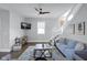 Bright living room featuring a ceiling fan, modern decor, and comfortable seating arrangement at 1724 Prospect St, Indianapolis, IN 46203