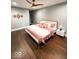 Serene bedroom with hardwood floors, a ceiling fan, and a stylish accent wall at 1724 Prospect St, Indianapolis, IN 46203