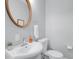 Cozy powder room with vanity, round mirror, and modern fixtures at 1724 Prospect St, Indianapolis, IN 46203