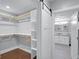 A walk-in closet leads to a double vanity bathroom with white cabinets and granite countertops at 1724 Prospect St, Indianapolis, IN 46203