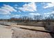Backyard featuring a gravel area, lawn, and a wood fence overlooking a pond at 1841 Sonesta Ln, Indianapolis, IN 46217