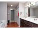 Bathroom featuring double sink vanity, wood flooring, and closet space at 1841 Sonesta Ln, Indianapolis, IN 46217