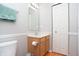 Neat bathroom featuring a wooden vanity, toilet, and large mirror at 1841 Sonesta Ln, Indianapolis, IN 46217