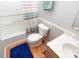 Well-lit bathroom featuring marble sink, toilet, and tiled shower at 1841 Sonesta Ln, Indianapolis, IN 46217