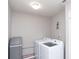 Practical laundry room with side-by-side washer and dryer, and water filtration system at 1841 Sonesta Ln, Indianapolis, IN 46217