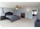 Spacious main bedroom featuring a ceiling fan, large bed, and adjacent sitting area at 1841 Sonesta Ln, Indianapolis, IN 46217
