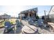 Inviting backyard features a fire pit with Adirondack chairs, a pergola, and a play set at 19149 Gillcrest Dr, Noblesville, IN 46062