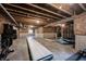 Basement gym with exercise equipment, exposed wood, and concrete foundation at 19149 Gillcrest Dr, Noblesville, IN 46062