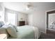Cozy bedroom with a plant, view to a second room and ceiling fan at 19149 Gillcrest Dr, Noblesville, IN 46062