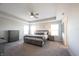 Spacious bedroom with neutral colors, tray ceiling, ceiling fan, and ample natural light from windows at 19149 Gillcrest Dr, Noblesville, IN 46062