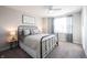 Bright bedroom featuring a black metal bedframe, stylish striped bedding, and a ceiling fan at 19149 Gillcrest Dr, Noblesville, IN 46062