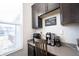 A coffee bar with dark wood cabinets, light countertops, decorative sign, and lots of natural light at 19149 Gillcrest Dr, Noblesville, IN 46062