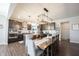 Spacious dining area with a modern chandelier, seamlessly connected to the beautiful, well-equipped kitchen at 19149 Gillcrest Dr, Noblesville, IN 46062