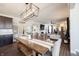 Bright dining area leading to a cozy living space, enhanced by a modern chandelier and stylish decor at 19149 Gillcrest Dr, Noblesville, IN 46062