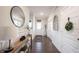 Elegant entryway with wainscoting, dark wood floors, and decor that welcomes you home at 19149 Gillcrest Dr, Noblesville, IN 46062