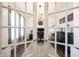 Bright home office viewed through glass doors, featuring a piano and desk set against shiplap walls at 19149 Gillcrest Dr, Noblesville, IN 46062