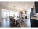 Spacious kitchen and dining area with stainless steel appliances, dark wood cabinets, and an island at 19149 Gillcrest Dr, Noblesville, IN 46062