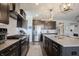 Bright kitchen showcasing stainless steel appliances, dark cabinets, and a subway tile backsplash at 19149 Gillcrest Dr, Noblesville, IN 46062