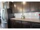 Close-up of kitchen counters, cabinets, subway tile backsplash, and stainless steel refrigerator at 19149 Gillcrest Dr, Noblesville, IN 46062