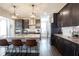 Modern kitchen with stainless steel appliances, dark wood cabinets, an island, and pendant lighting at 19149 Gillcrest Dr, Noblesville, IN 46062