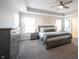 Spacious main bedroom featuring a tray ceiling, ceiling fan, and multiple windows for natural light at 19149 Gillcrest Dr, Noblesville, IN 46062