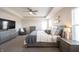 Comfortable main bedroom with a sitting area, ceiling fan, and neutral decor at 19149 Gillcrest Dr, Noblesville, IN 46062